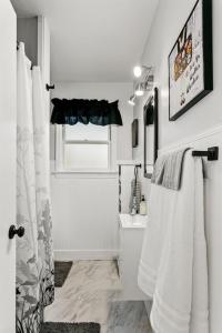 a white bathroom with a toilet and a sink at CUTE Remodeled Midcentury Cottage on Boise Bench in Boise