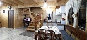 una cocina con mesa y sillas en una cabaña en Cabana Ana en Muntele Rece