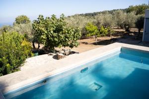 The swimming pool at or close to Chaihoutes stone villa into Olive farm in Zia