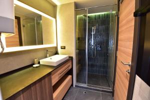 a bathroom with a sink and a shower at Woodside Kopaonik Residences in Kopaonik +15 photos