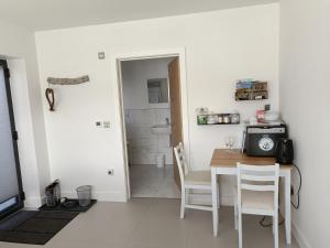 a kitchen and dining room with a table and chairs at Petite Anchorage in Christchurch