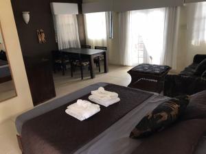 a living room with a bed with towels on it at Moxons Beach Club in Boscobel