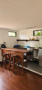 a kitchen with a wooden table and two stools at Casa Wolaba in Puerto Limón