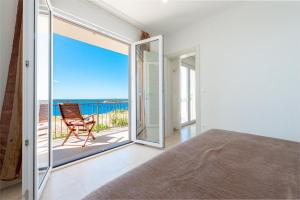 a bedroom with a view of the ocean at Apartments Mrkan in Cavtat