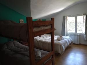 a bedroom with two bunk beds and a window at Posada Copahue in San Carlos de Bariloche