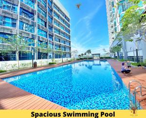 a large swimming pool in front of a building at Sweet Tree Homestay Petaling Jaya in Petaling Jaya