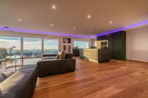 a large living room with a couch and a table at Moderne Villa mit Whirlpool und Heimkino in Waldkirchen