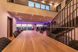 a long wooden table in a room with chairs at Moderne Villa mit Whirlpool und Heimkino in Waldkirchen