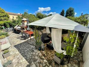 una sombrilla blanca con silla y piano en Apartments Villa Herak, en Poreč