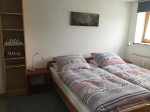 a bed with pillows on it in a room at Ferienwohnungen Fuchssteige in Heidenheim an der Brenz