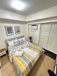 a bedroom with a large bed in a room at 1BR Condo Unit at Celandine Condominium Near Ayala Cloverleaf Mall in Manila