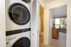 a kitchen with a washer and dryer in a house at Maui Kamaole B207 in Wailea
