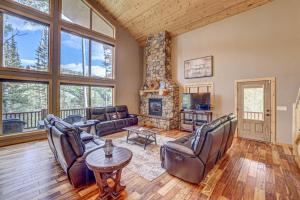 a living room with leather furniture and a fireplace at Pinehurst Retreat in Brian Head