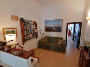 a living room with a couch and a book shelf at Il Sorriso in Orvinio