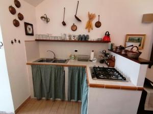 a kitchen with a sink and a stove at Il Sorriso in Orvinio