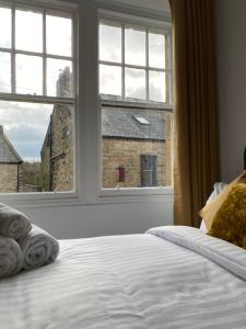 a bedroom with a bed and a large window at Ship Inn Stays Ltd in Wylam