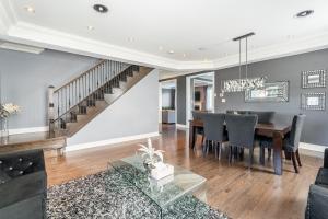 a dining room and living room with a table and chairs at Beautiful Family Villa, Pond Facing with Huge Backyard in Brampton