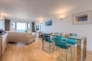a living room with a glass table and a couch at Viridian in Carbis Bay