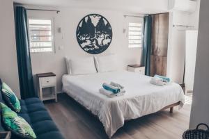 a bedroom with a bed with towels on it at TIKI street side Studio with shared water front terrace at Grand Case in Grand Case