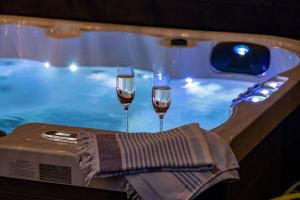 two glasses of wine on a tray next to a swimming pool at Anoush in Everton