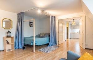 a bedroom with a bed with blue drapes at Lovely Old Riga studio in Rīga