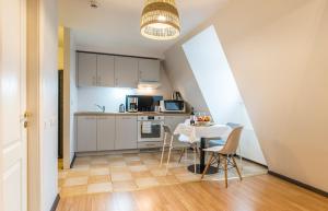 a kitchen and dining room with a table and chairs at Lovely Old Riga studio in Riga
