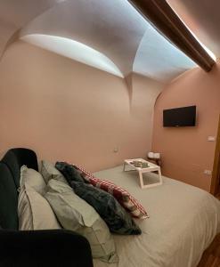 a living room with a bed and a tv at Rose Apartment in Terlizzi