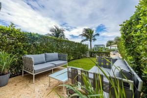 a patio with a couch and a table at Azure Beach Residences in Palm-Eagle Beach