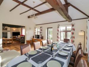 a dining room with a table and chairs at Meadowfields in Kidderminster
