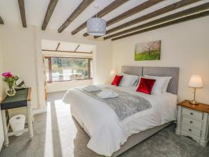 a bedroom with a large bed and a desk at Meadowfields in Kidderminster