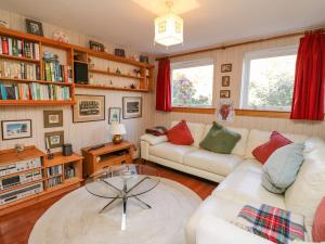 a living room with two couches and a glass table at Bourblach in Mallaig