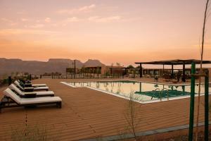 a resort with a pool and mountains in the background at Cloud 7 Residence AlUla in AlUla