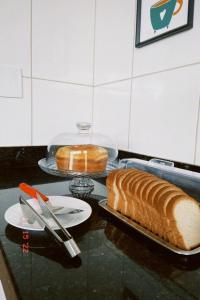 una mesa con una barra de pan y un plato de pan en Pousada Ritec, en Linhares