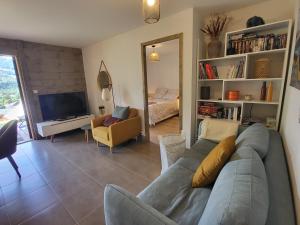 a living room with a couch and a television at Le Criou - 3 bedroom apartment 5 minutes walk to the village centre in Samoëns