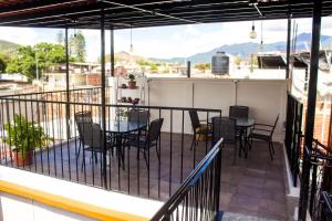 a balcony with a table and chairs and a view at Casa Gubidxa in Oaxaca City