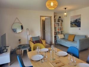 a living room with a table and a couch at Le Criou - 3 bedroom apartment 5 minutes walk to the village centre in Samoëns
