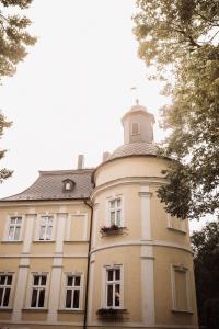 um edifício com uma torre de relógio em cima em Hotel Zamek Chałupki em Ruderswald