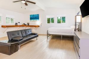a living room with a bed and a couch at Puni Mauka B 31 plus day rental in Pahoa