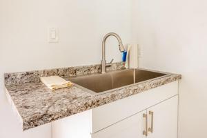 a kitchen with a sink and a counter top at Puni Mauka B 31 plus day rental in Pahoa