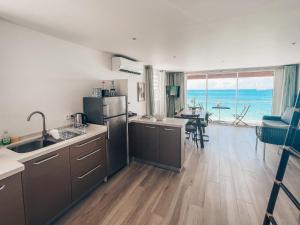 a large kitchen with a view of the ocean at PARADISE VIEW 1 bed-room water front studio at Grand Case in Grand Case