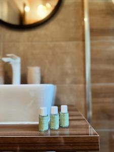three bottles of essential oils sitting on a table in a bathroom at CASA MIA in Kupres