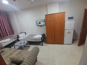A television and/or entertainment centre at Farah Plaza Hostel &Hotel Apartments