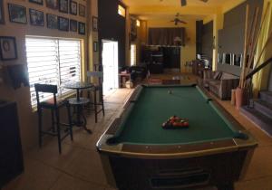 a pool table in the middle of a living room at Moxons Beach Club in Boscobel