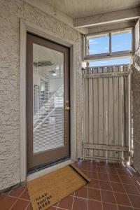 a glass door in a room with a window and a mat at Studio on the Lake w/ Pool, Hot Tub & Tennis in Chandler