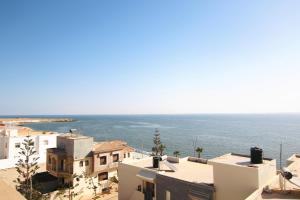 a view of the ocean from the roofs of buildings at Dakhla White Hotel in Dakhla