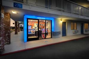 a store front with a blue lighted door in a building at Motel 6-Arcadia, CA - Los Angeles - Pasadena Area in Arcadia