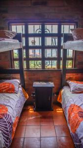 a room with two bunk beds and a window at Casa de Arte Monte Sinaí in Medellín