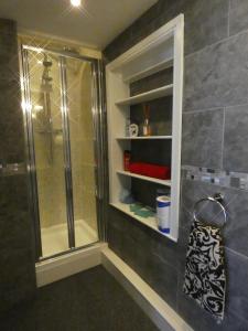 a bathroom with a shower and a glass shower at Victoria Villas in Sandycroft