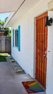 a door to a house with a colorful rug next to it at Newly Remodeled Mid Century Saguaro House (36) in Phoenix