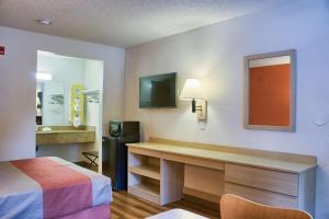 a room with a bed and a desk with a television at Motel 6-Seattle, WA - South in SeaTac